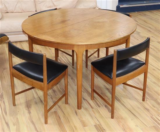 An H. McIntosh & Co Ltd circular extending dining table and four chairs, model 9533 table diameter 122cm closed